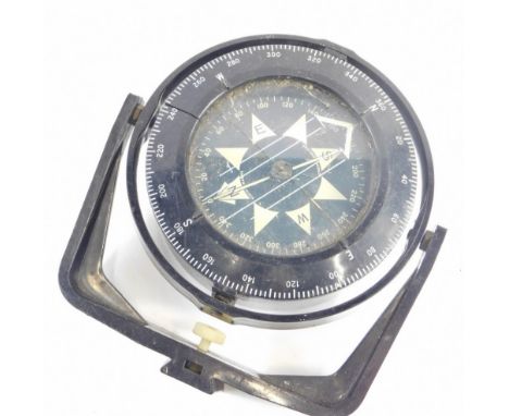 A metal cased ship's compass, with white stencilled Arabic dial, in plastic casing.