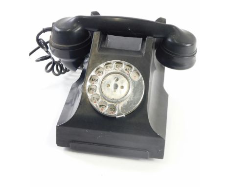 A vintage black Bakelite telephone, with simulated drawer to the front, 24cm wide.