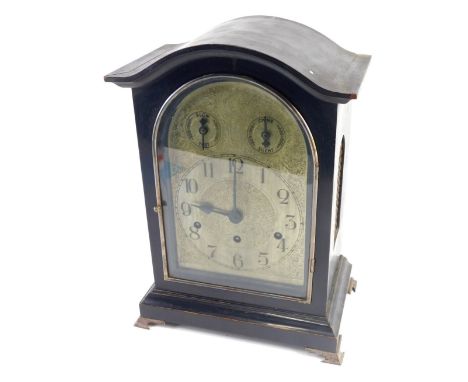 A 19thC ebonised bracket clock, the 17cm wide engraved domed back plate with Arabic dial fitted in an arched case on bracket 