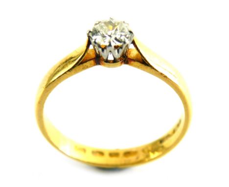 A diamond solitaire ring, set with round brilliant cut diamond, approximately 0.30 carat, in a claw setting, on a yellow meta