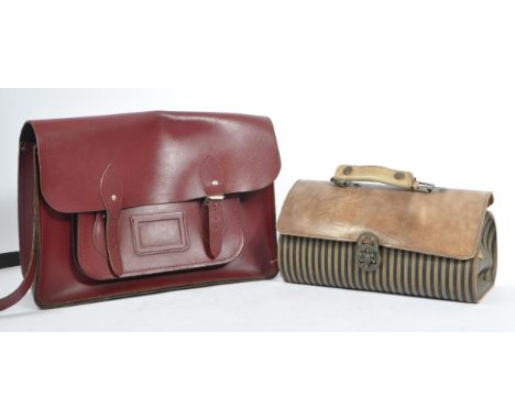 A cherry red leather satchel by The Cambridge Satchel Company. With red stitching, shoulder strap and provision for name and 