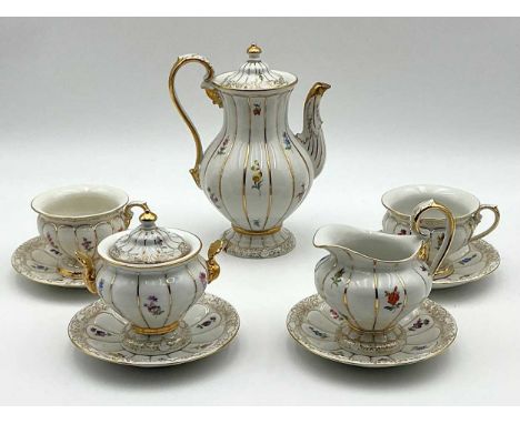 A Meissen mocha set for four, painted with flowersrubbing to gilt throughoutlight scratching and minor crazing consistent wit