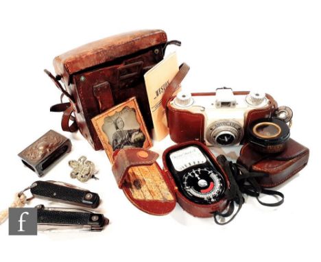 A pair of early Goertz grey painted binoculars, cased, an Advocate camera, a Western Master II light meter, pocket knives and