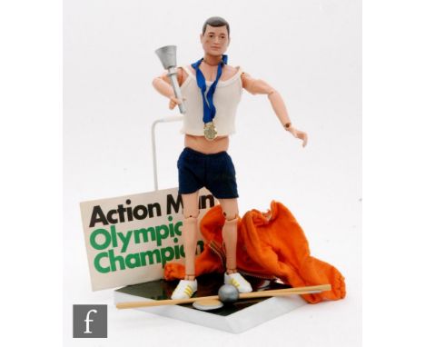 A Palitoy Action Man Action Soldier first type action figure with painted hair with a complete 1969 Olympic Champion set, com