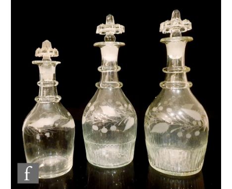 A matched pair of two early 19th Century Irish decanters, each of tapering form with basal moulding below foliate motifs and 