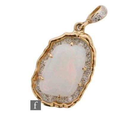 An 18ct hallmarked opal and diamond pendant, irregular claw set opal above a pave diamond set ground and diamond set pendant 