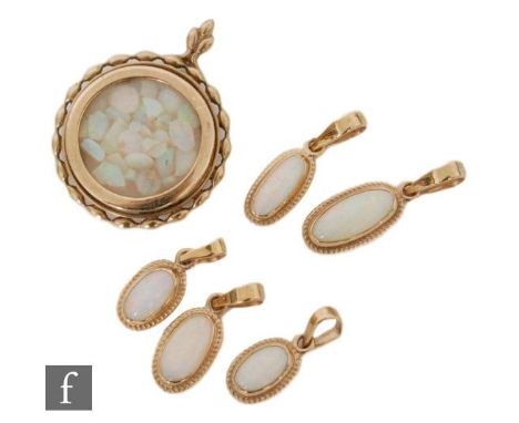 Five 9ct hallmarked single stone oval, collar set opal pendants, longest stones approx 12mm, with a circular pendant containi