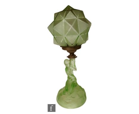 A 1930s Art Deco Walther &amp; Sohne table lamp, formed as a kneeling female nude upon a rocky outcrop, with a faceted and fr