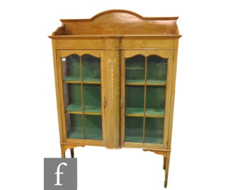 An Edwardian marquetry inlaid mahogany display cabinet, enclosed by a pair of bar glazed doors below a shelf, on square taper