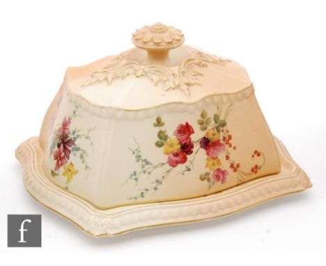 An early 20th Century Royal Worcester blush ivory butter dish and cover decorated with floral sprays with gadrooned edges and