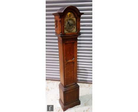 An early 20th Century oak cased Grandmother clock with a German 8-day movement striking on eight gongs, stamped 'Embee' to th