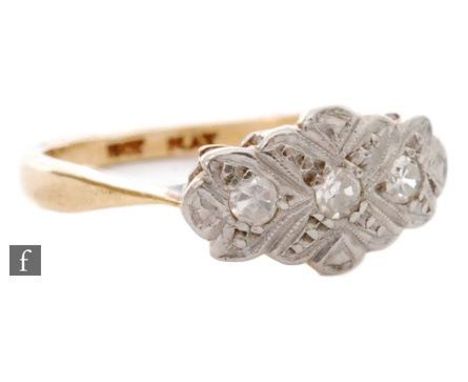 An early 20th Century 18ct diamond cluster ring with oval platinum head set with three diamonds to knife edged shoulders, rin