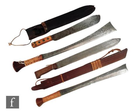 A Naga tribe Dao short sword and wooden scabbard, a similar sword, 50cm blade and two machetes one with wooden and leather sc