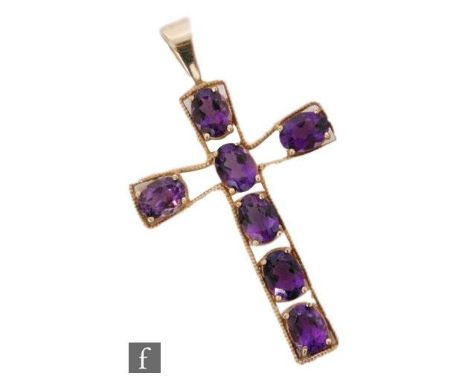 A 9ct cross set with seven oval amethyst stone to axis, length 5cm, weight 5g, unmarked. 