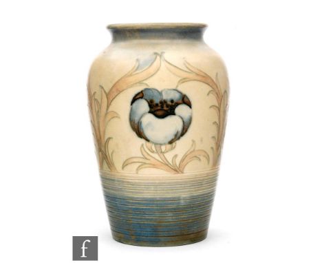 A William Moorcroft vase of shouldered ovoid form, decorated in the Anemone pattern, with tubelined large flower heads and fo