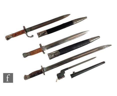 A 1913 Remington pattern bayonet, a similar bayonet, a Sanderson pattern bayonet and scabbard and a No 4 MK II socket bayonet