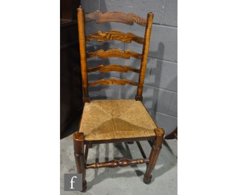 A set of six 20th Century ash and rush seat ladder back dining chairs on turned legs and stretchers. (6) 