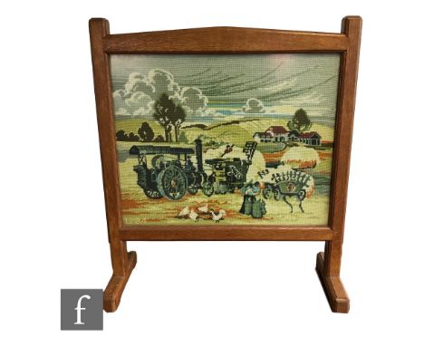 An oak framed firescreen, in the manner of Brynmawr Furniture Makers Ltd, with later woolwork tapestry panel depicting a haym