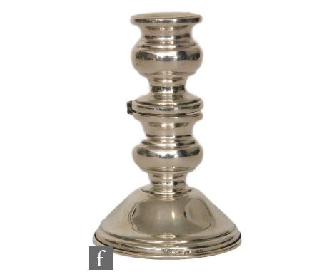 A continental silver novelty candlestick, circular stepped base below hinged mid section to convert to a double stick, height