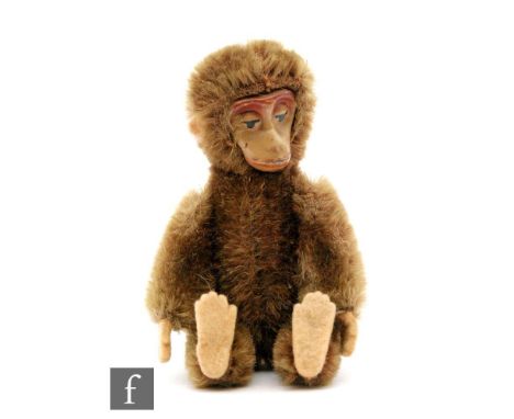 A 1950s Schuco Janus 'two face' miniature teddy bear, cinnamon mohair, one face with black bead metal eyes, nose and mouth wi