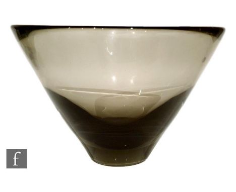 A post war Holmegaard glass bowl designed by Per Lutken, of asymmetrical flared form in a deep cinnamon tint, engraved signat