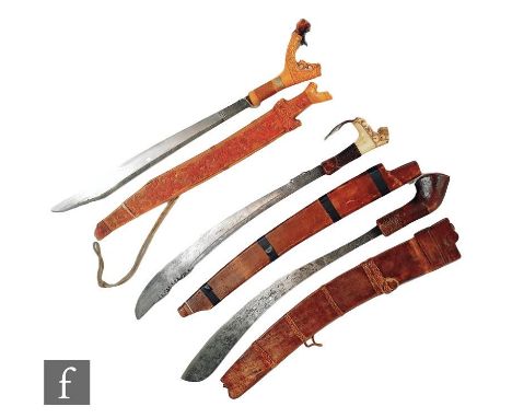 A Mandu knife and scabbard with bone handle and engraved blade, a similar knife and scabbard and a Golok Malaya jungle knife 