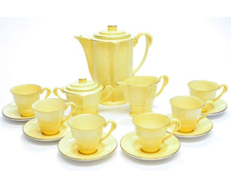 A Carlton Ware coffee set, double ogee form with everted rims, in pale yellow, highlighted in gilt, he handles of nautralisti