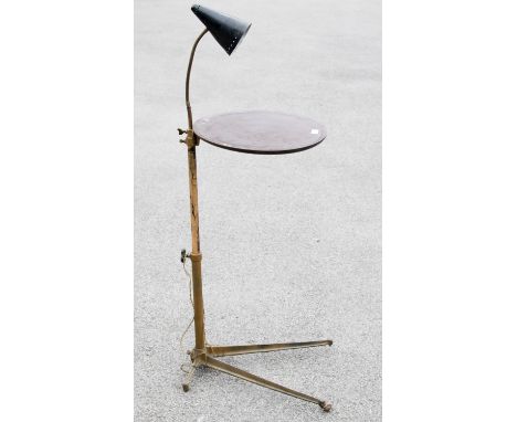 A 1950s industrial cast iron and mahogany height adjustable occasional table, tubular steel on crows foot base, the circular 