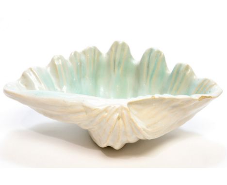 A faience pottery shell bowl, realistically modelled, in the style of Poole, turquoise interior, painted marks and monogram, 