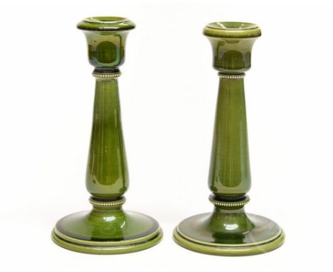 A pair of Ault, art pottery green glazed candlesticks, with beaded borders, impressed signature marks, 23cm high, together wi