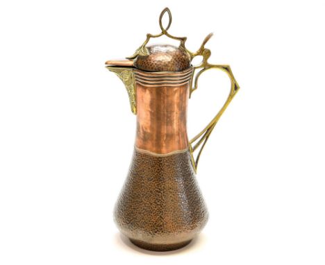 Jan Eisenloffel (attributed) for Fritz and Robert Fischer, a Jugendstil coper and brass mounted claret jug, baluster form, th
