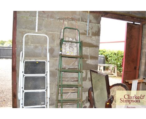 A metal step ladder; and a wooden step ladder 