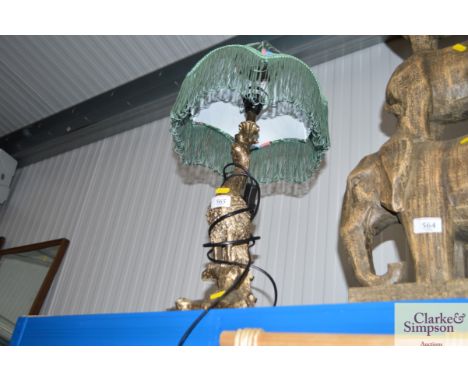 A table lamp in the form of a peacock and shade