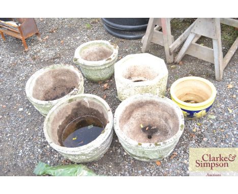 Five concrete planters and a glazed planter