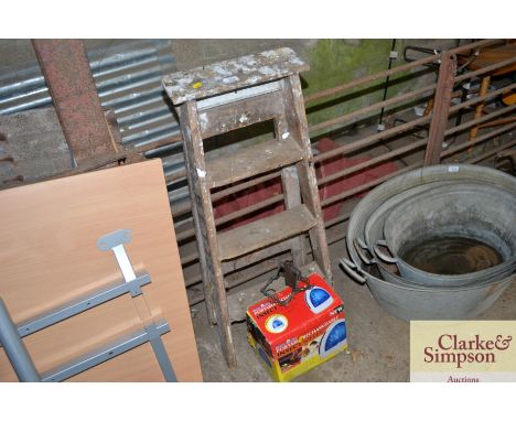A wooden step ladder and a portable rechargeable insect repeller and a trap