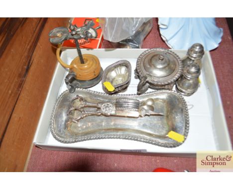 A box containing silver plated chamber stick; silver salt and  other silver plated items