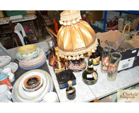 A pottery table lamp; various alcohol; souvenir dolls; Scotch Whisky ashtray
