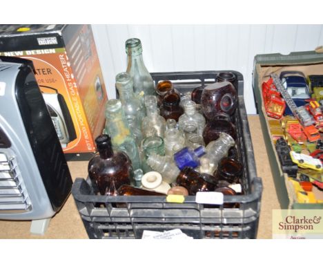 A box of vintage glass bottles and jars