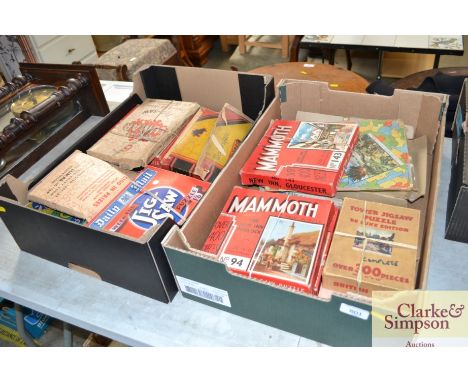 Two boxes of vintage cardboard jigsaw puzzles including WWII period