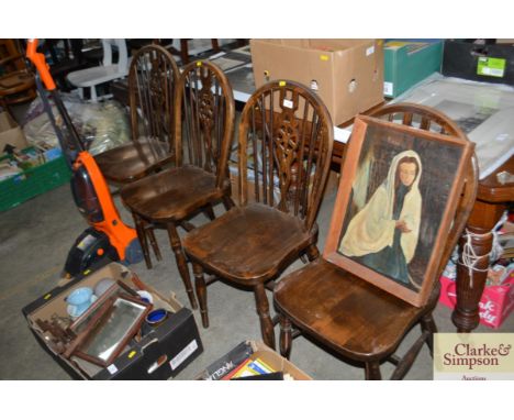 A set of four stick and wheelback dinning chairs
