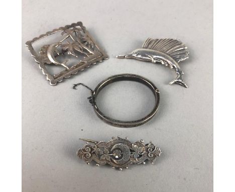THREE SILVER BROOCHES, along with a baby's bangle (4)