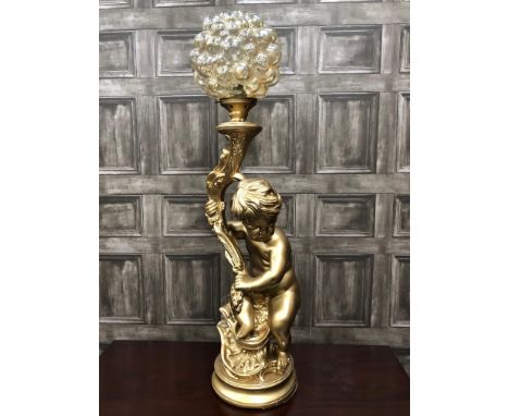 20TH CENTURY GILT PAINTED TABLE LAMP, modelled in the form of a seated cherub holding aloft a glass shade, 92cm high