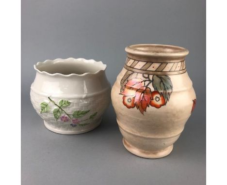 CROWN DUCAL VASE, with tube lined floral decoration in the style of Charlotte Rhead, 18cm high, along with a Belleek planter 