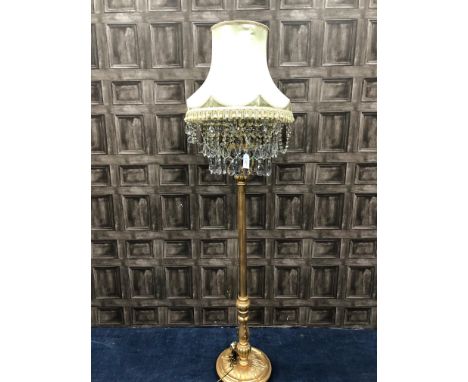 GILDED WOOD STANDARD LAMP, with a fringed shade above rows of prismatic drops, 197cm high