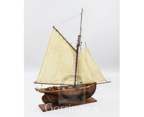 A 1930's apprentice scratch built shipbuilder's model of the cutter, 'Edith', on mahogany stand, H.53in.