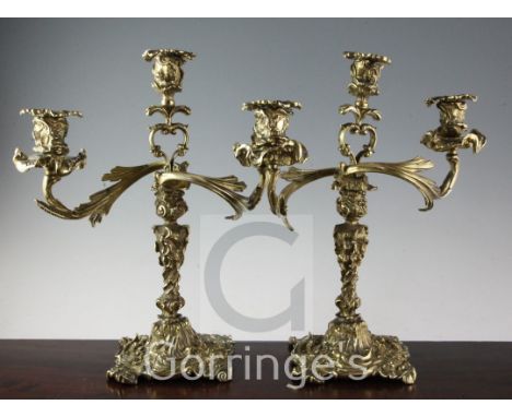 A pair of 19th century French cast brass three light candelabra, of rococo scroll form, 16in.