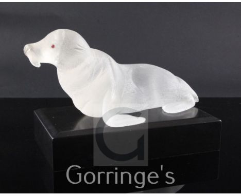 A 1960's rock crystal figure of a sea lion, in Cartier style, ruby cabochon eyes, ebonised plinth, 28cm