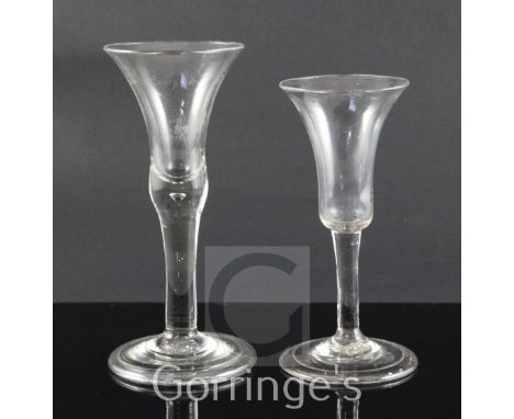 Two drinking glasses, c.1740, the first with a funnel shaped bowl, diamond point engraved inscription to King George, folded 