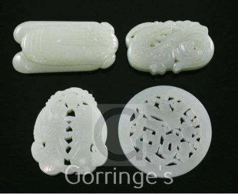 Four Chinese celadon jade plaques, carved as twin fish, a cicada, an archaistic chi-dragon and a disc pierced with the charac