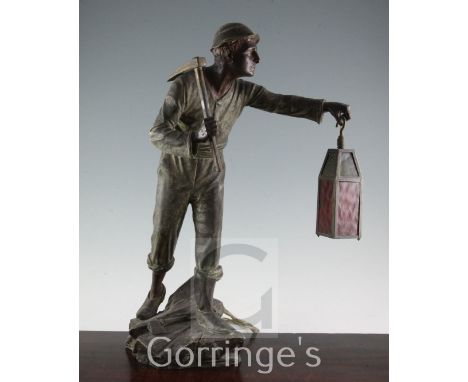 A late 19th century bronzed spelter table lamp, modelled as a tin miner, H.21in.